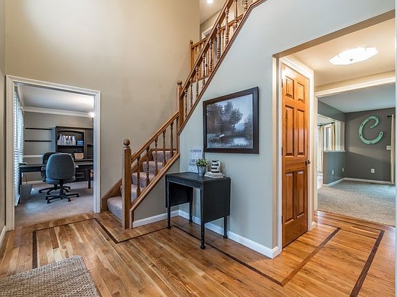 2 Story foyer with freshly refinished hardwood floors, Entry door features full sidelites with transom.