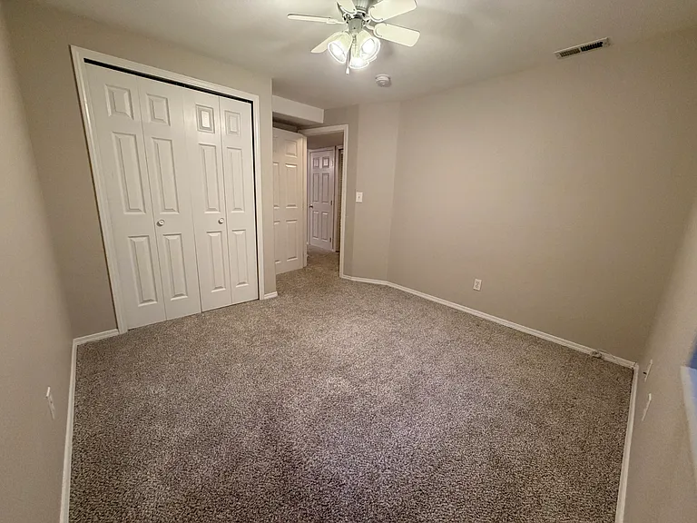 Additional view of the third bedroom highlighting the spacious layout, closet storage, and flexibility for use as a guest room, office, or personal retreat.