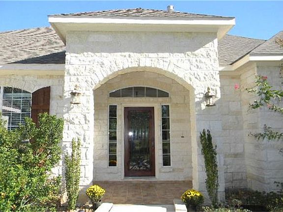The beautiful custom iron and mahogany door & tiled front porch welcome you in to this amazing home!