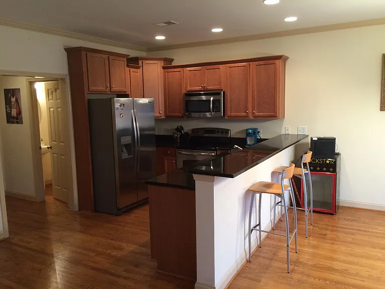 Kitchen and front hall bath (former tenant stools shown not included). Does not reflect crown molding and walls having been painted lighter white color.