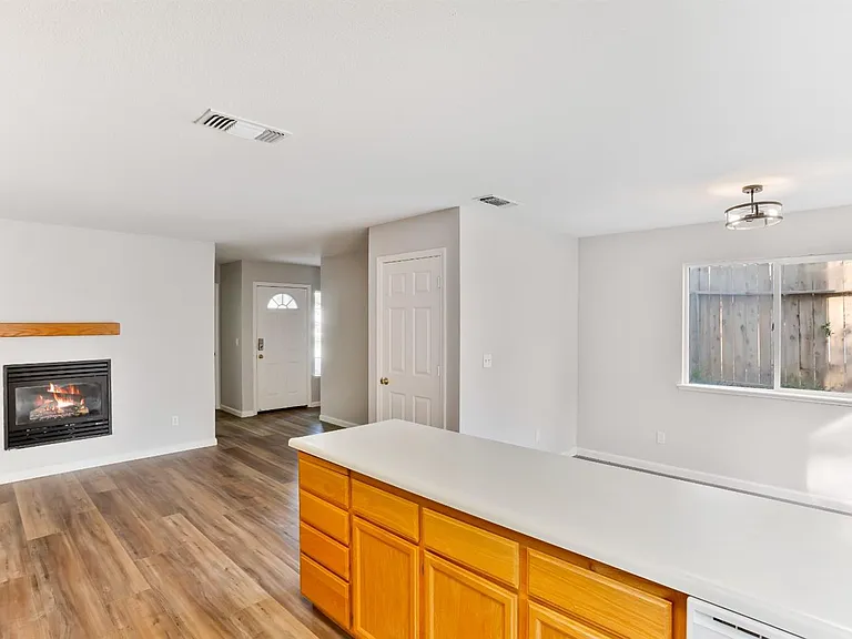 The view of the family room & dining room from the kitchen.