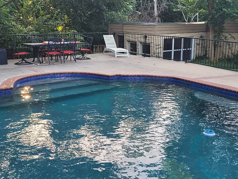 Pictured from behind, across pool and can see the bungalow/pool house in the back. Tenant has access to grounds and to the pool. Only the owner's family of 4 live on the 2 acres with tenant.