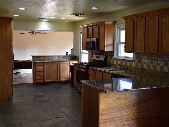 Granite countertops, dishwasher, disposal, refrigerator and gas range