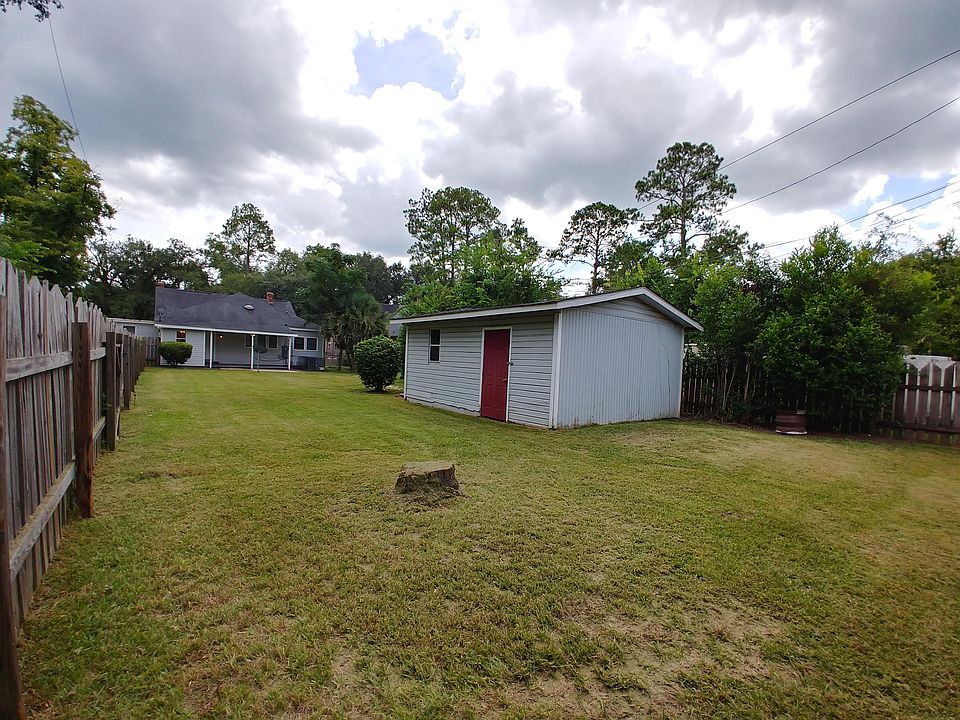 Covered patio, large fenced yard, storage building