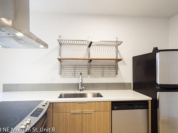 Kitchen features stainless steel appliances, refrigerator and dishwasher.