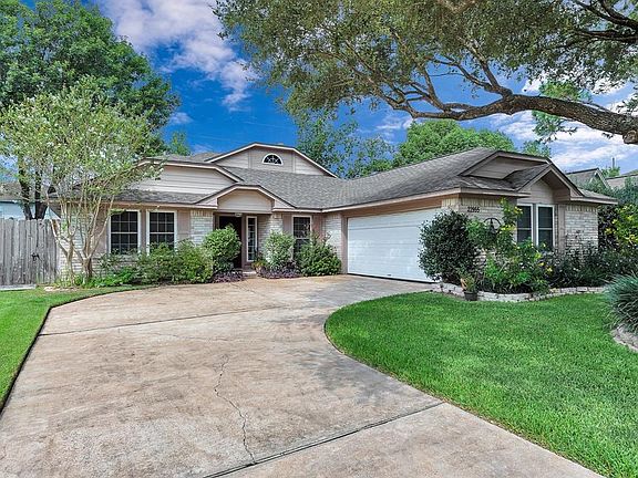 Great curb appeal on this house with mature trees and colorful plants