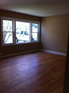 Living room with new vinyl triple windows.