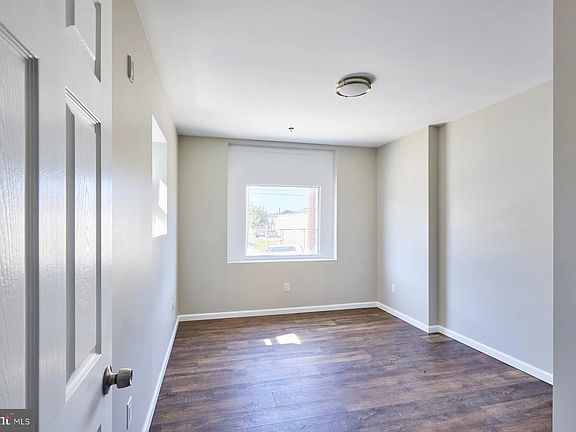 Front room with plenty of natural light. May be used as a study, bedroom or living room.