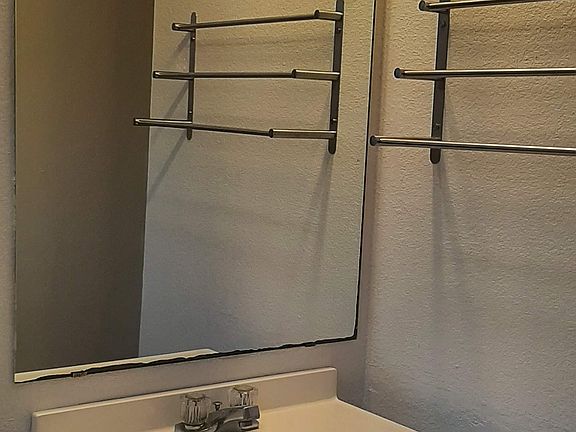 Bathroom has vanity, shower, stool and laundry hook ups.