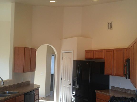 Updated appliances in open concept kitchen with vaulted ceilings/ recessed lighting.