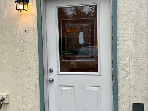 Unit's front door, just in front of the tenant's driveway parking space.