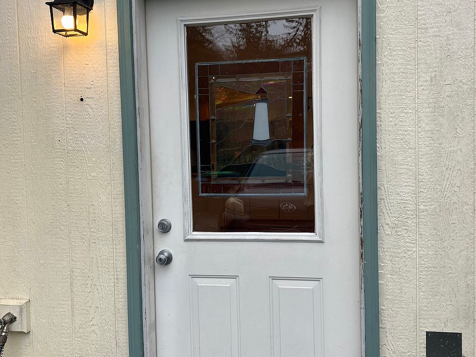 Unit's front door, just in front of the tenant's driveway parking space.