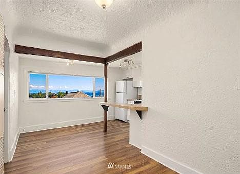 Living room and dine in counter. Nice and bright with to die for views.