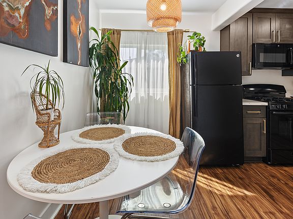 Dining area flows into the open kitchen, with a full sized refrigerator, microwave, gas stove, and oven.