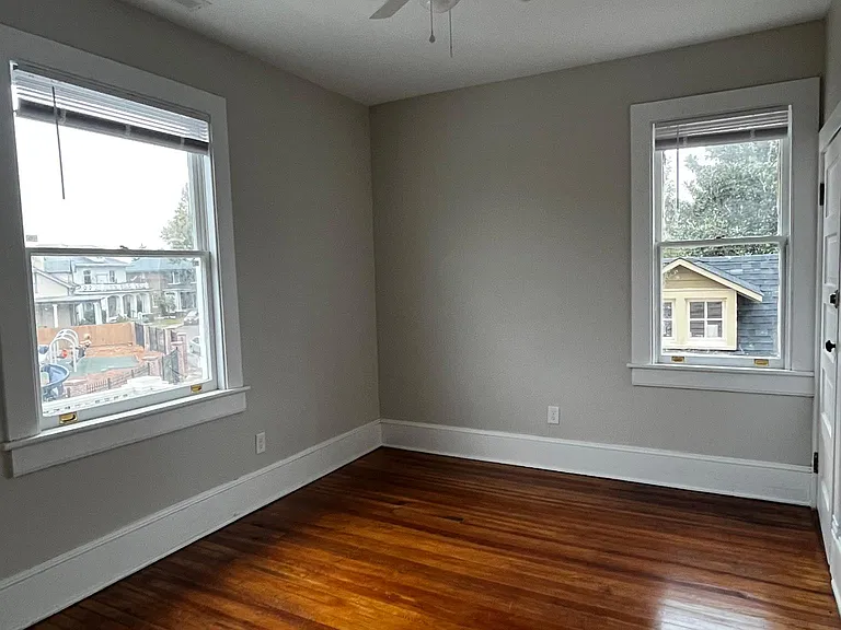Front bedroom with ample closet space and room darkening blinds