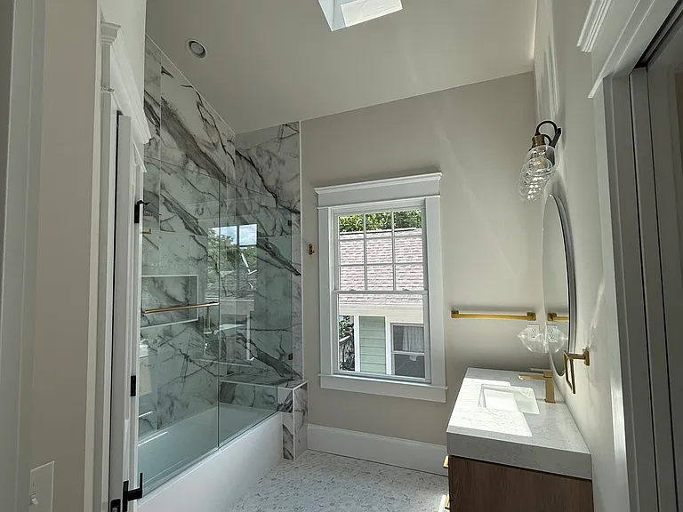 second bath with bidet closet to the left and vaulted ceiling skylight