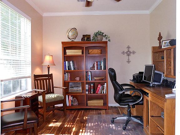 To the left of the entryway lies your study with crown moulding and cheery window overlooking the fr