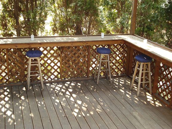 Private covered deck ith wrap-around bar