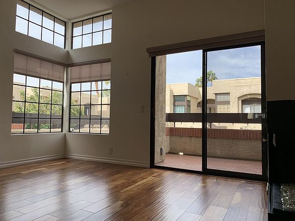 Living room with near floor to ceiling windows. Custom window coverings.