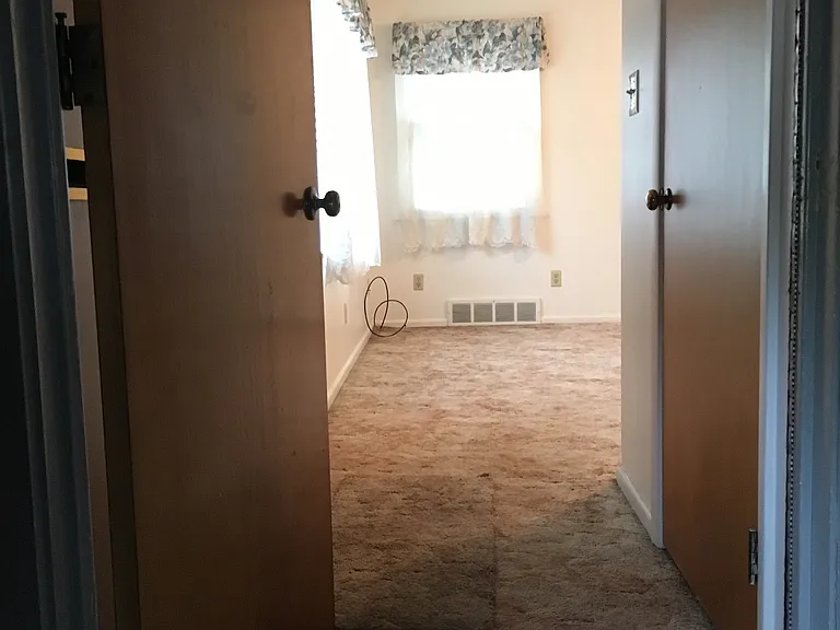Entry hall from Garage, Front Door with closet to right and Living Room beyond.