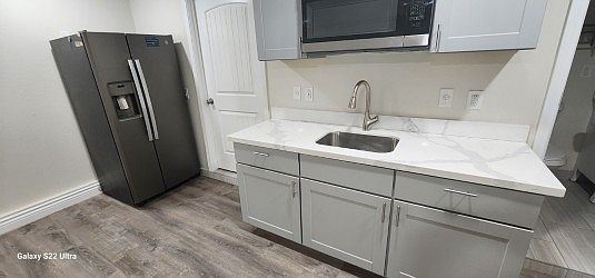 Beautiful kitchenette with microwave, 6 power sockets for your appliances, and a double side by side door fridge.