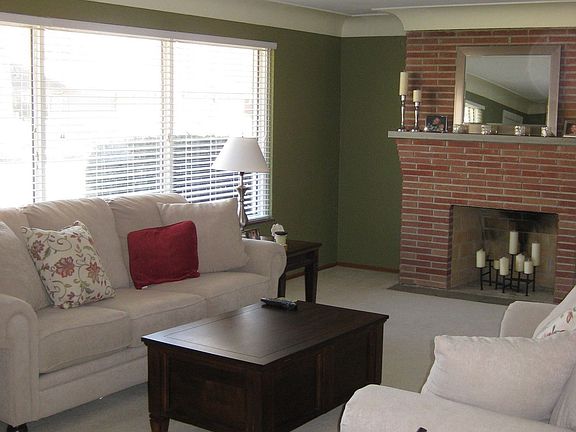 living room with brick fireplace