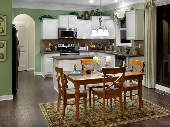 The dining area adjoins the open kitchen. Oversized sliding glass doors bring in tons of natural lig