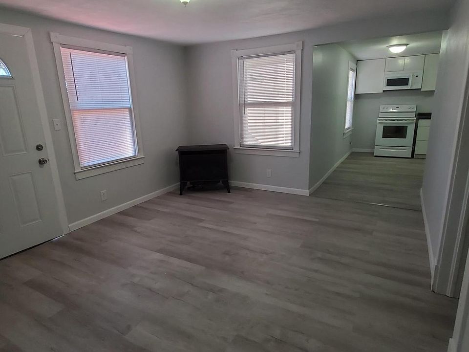 Living Room and hallway to Kitchen. Hardwood laminate floors throughout the apartment.