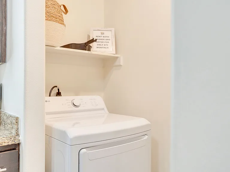 Stylish laundry room showcasing a contemporary washer and dryer, found in La Joya Apartments, Laredo, Texas