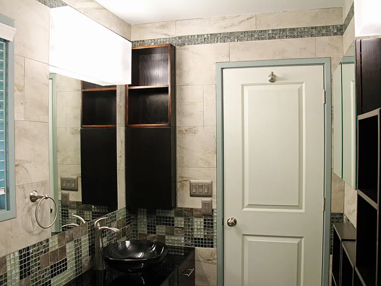Full bathroom with built-in cabinets.