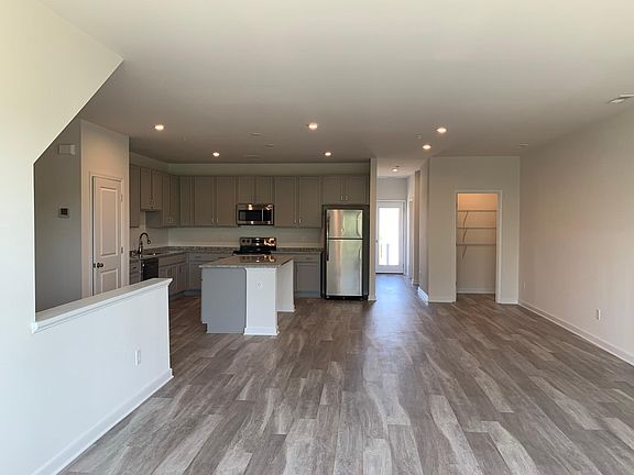 Main floor with kitchen, pantry, family room, dining area, office (or bedroom) space, half bath, balcony and two extra spaces.