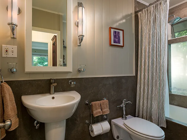 Main floor full bath with shower, pressure toilet and washing basin