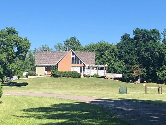Distant street view of front side of home. As well as Front and back yard.