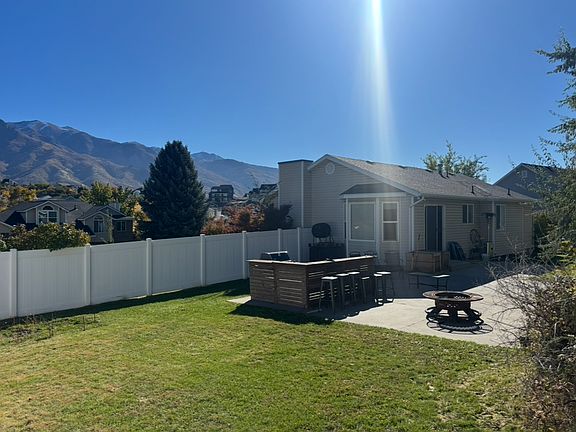 Current back yard with out door bar and fire pit, which can be purchased from tenants.