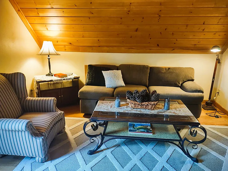 Guest House Living Room: Spacious & Cozy Living Room with Queen Size Pull Out Sofa, Queen Anne Chair, Large Screen TV & Enjoy the Morning Sunshine on Balcony with Table & Chairs