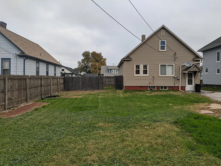 Large, flat grass yard ready for kids to play in!
