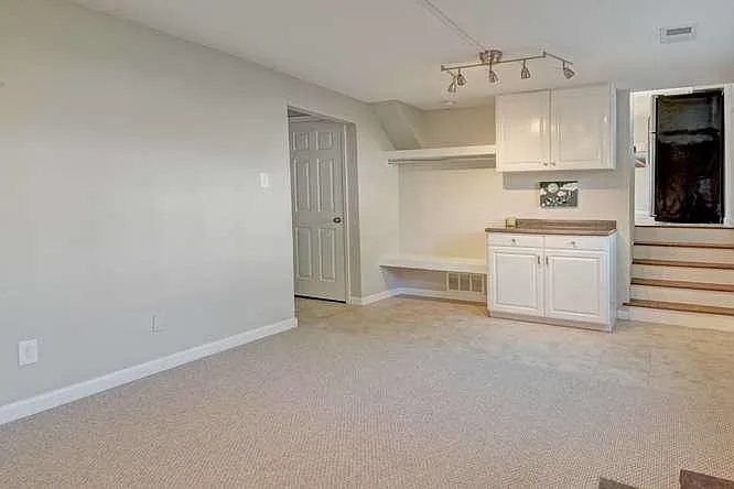 Family room with laundry cabinets/hanger- washer/dryer just