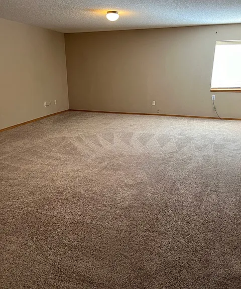 Family room in basement with daylight windows