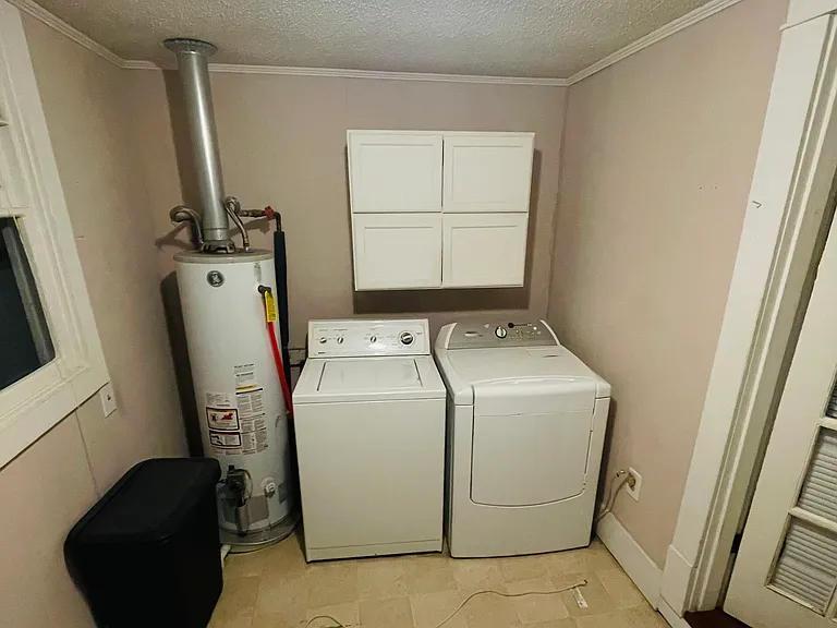 New washer and dryer and storage room.