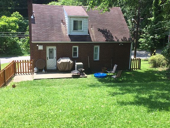 Back yard with concrete patio. Retractable awning to be ins