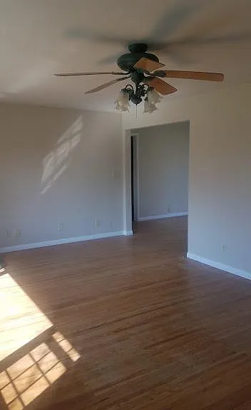 Living Room w/ ceiling fan & Hardwood floors