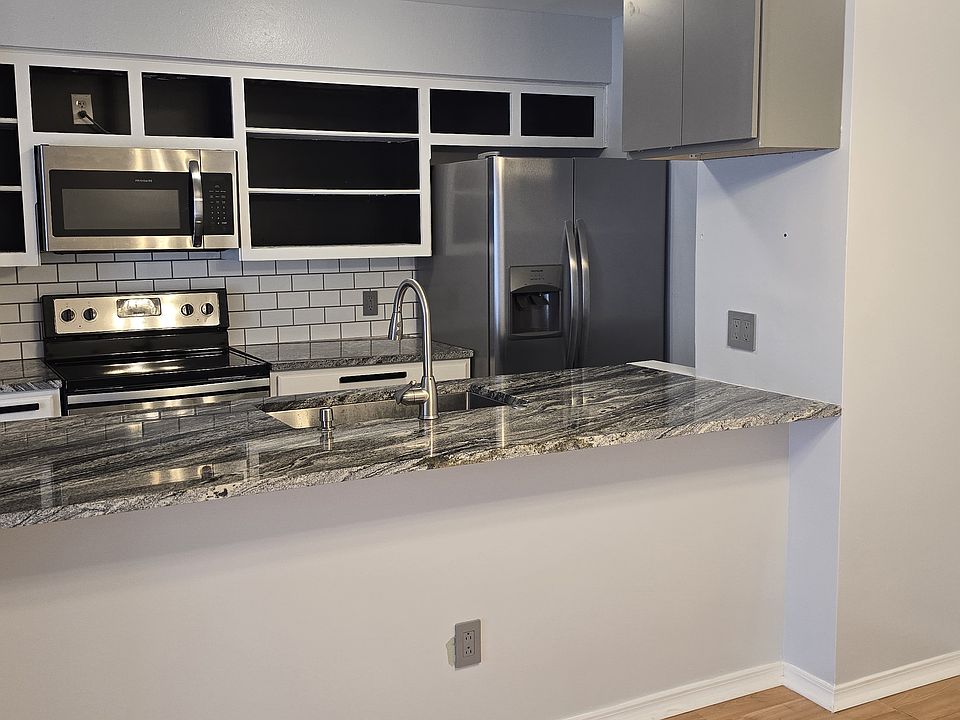 Kitchen - in-unit appliances include refrigerator, dishwasher, range, and microwave