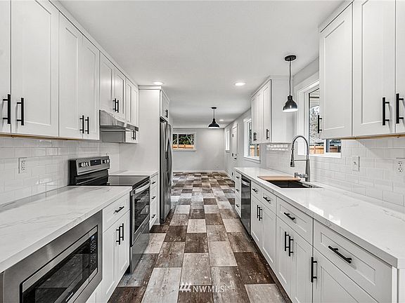 All new appliances, cabinets and floors in the light bright kitchen