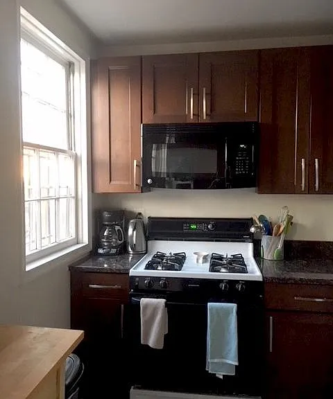 Kitchen with gas oven and stovetop and microwave