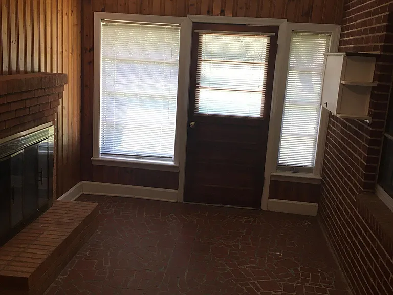 Breezeway between garage and kitchen with door going to backyard
