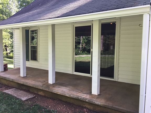 Side porch with sliding glass door into dining area