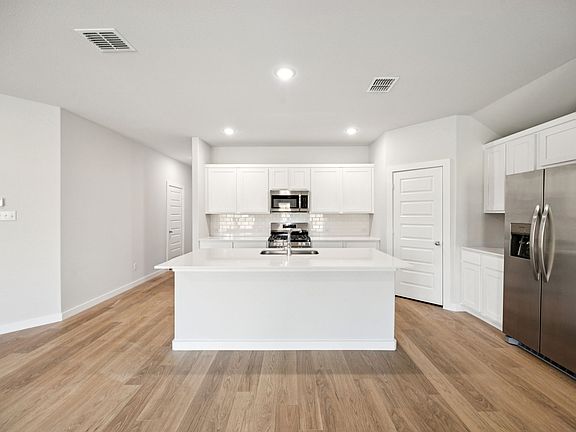 Kitchen in the Emmy II home plan by Trophy Signature Homes - REPRESENTATIVE PHOTO