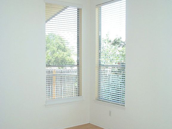 Master bedroom with wood floors & high cielings.  Windows overlook back yard.