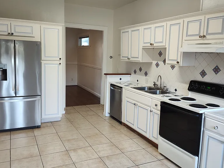 standing in back door looking at kitchen and dining room beyond