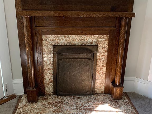 Stunning fireplace, original to the structure. Tile imported from Italy in the 1920's.